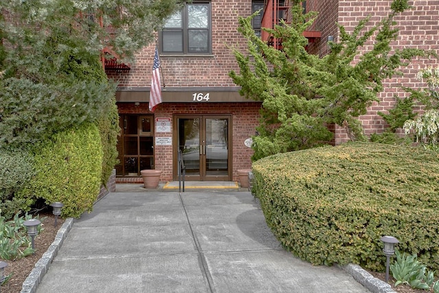 doorway to property with french doors and brick siding
