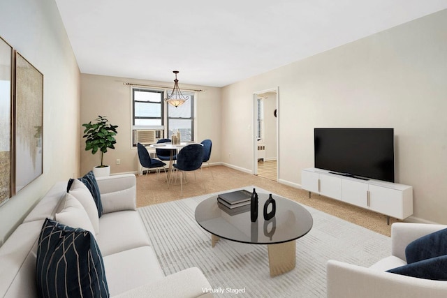living area with baseboards and light carpet