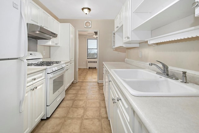 kitchen with white appliances, radiator heating unit, white cabinetry, under cabinet range hood, and a sink