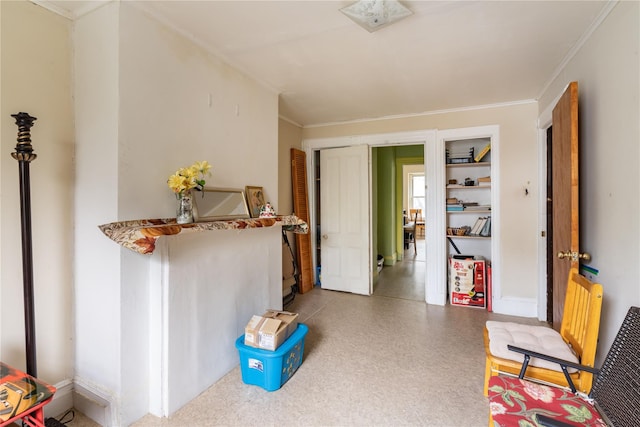 interior space with baseboards and crown molding