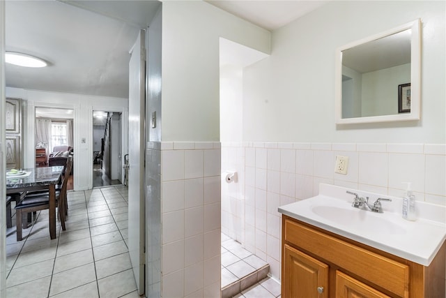 bathroom with tile walls, a wainscoted wall, tile patterned floors, and vanity