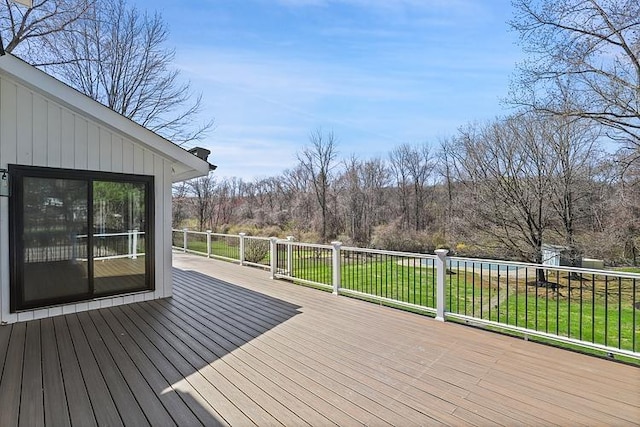 wooden terrace with a lawn