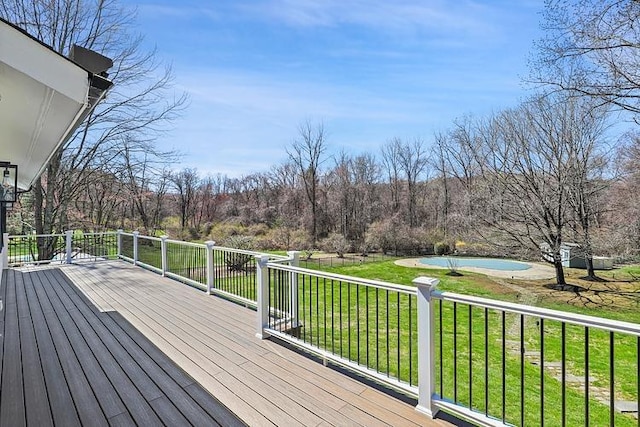 wooden terrace featuring a lawn