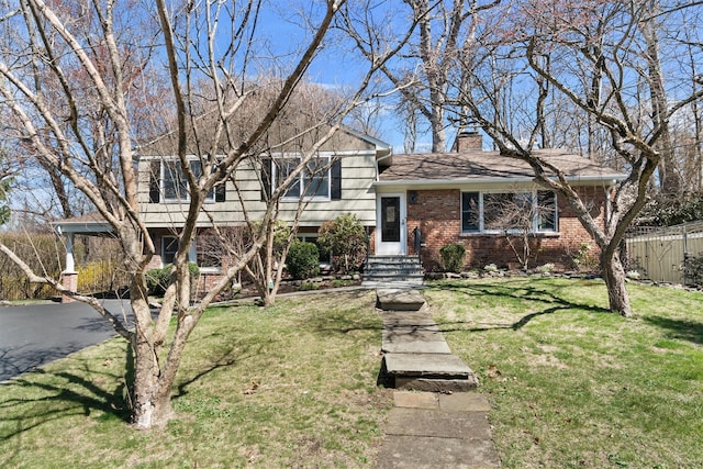 21 Glengary Rd, Croton-On-Hudson, NY 10520 - split level home featuring a chimney, fence, a front lawn, and brick siding