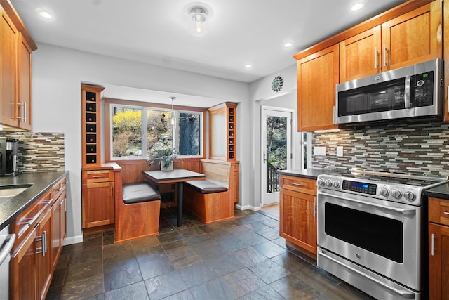 21 Glengary Rd, Croton-On-Hudson, NY 10520 - kitchen featuring tasteful backsplash, appliances with stainless steel finishes, a healthy amount of sunlight, and stone tile floors