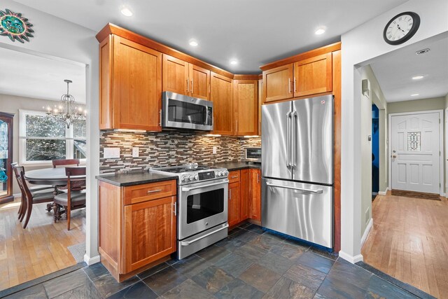 21 Glengary Rd, Croton-On-Hudson, NY 10520 - kitchen with stainless steel appliances, tasteful backsplash, stone tile flooring, and dark countertops