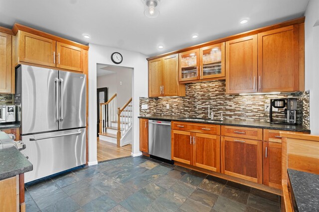 21 Glengary Rd, Croton-On-Hudson, NY 10520 - kitchen with tasteful backsplash, glass insert cabinets, brown cabinetry, stainless steel appliances, and a sink