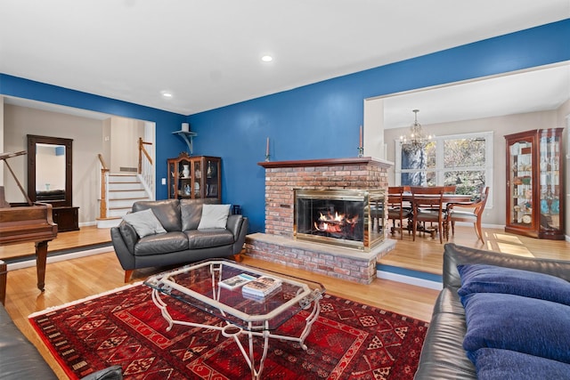 21 Glengary Rd, Croton-On-Hudson, NY 10520 - living area featuring stairway, a notable chandelier, wood finished floors, and a fireplace