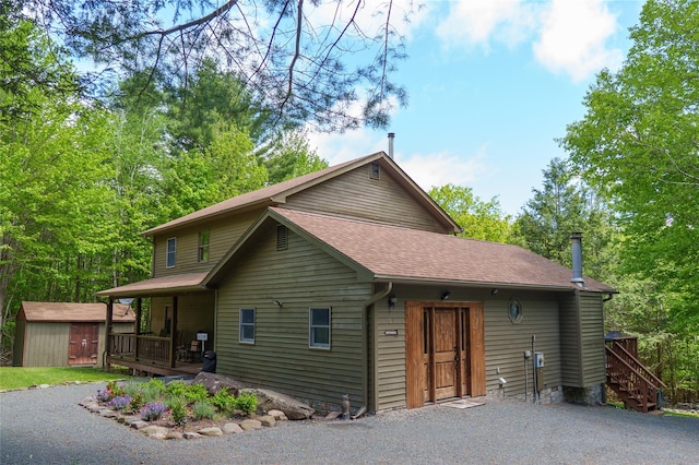 61 Mount View Estates Rd, Ashland, NY 12407 - view of front of property with a storage unit, a shingled roof, a porch, and stairway