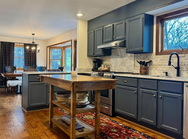 61 Mount View Estates Rd, Ashland, NY 12407 - kitchen featuring stainless steel range oven, under cabinet range hood, a chandelier, dark wood-style floors, and light countertops