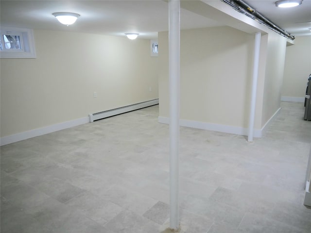 basement featuring baseboards and a baseboard heating unit