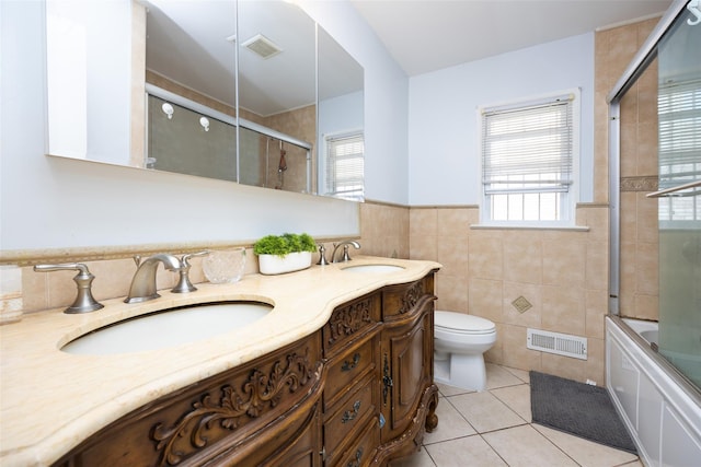 bathroom featuring tile patterned floors, visible vents, and a sink