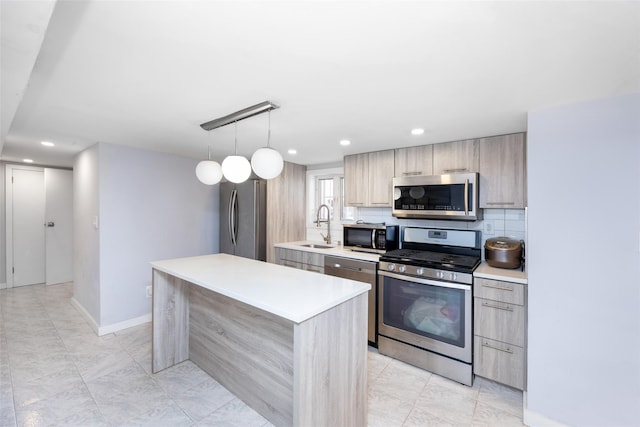 kitchen featuring light countertops, a sink, tasteful backsplash, modern cabinets, and stainless steel appliances