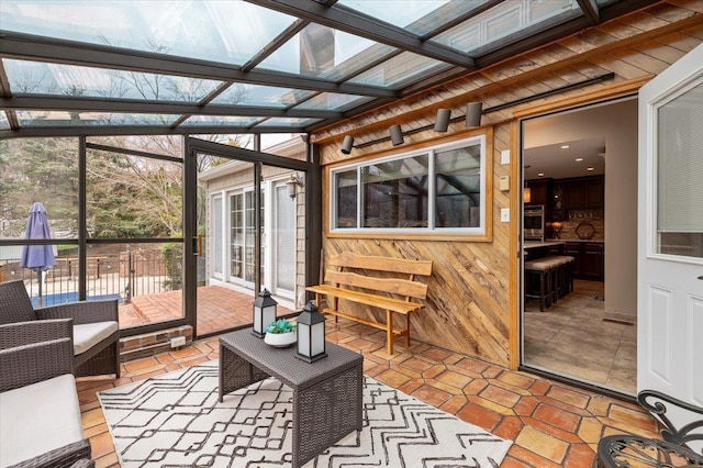 sunroom featuring an outdoor living space