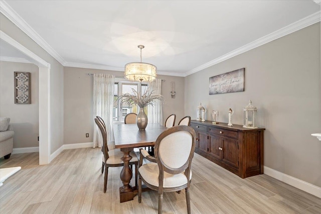 dining room featuring baseboards, an inviting chandelier, and light wood-type flooring