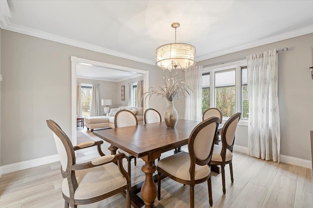 dining area featuring baseboards, a notable chandelier, light wood-style floors, and crown molding