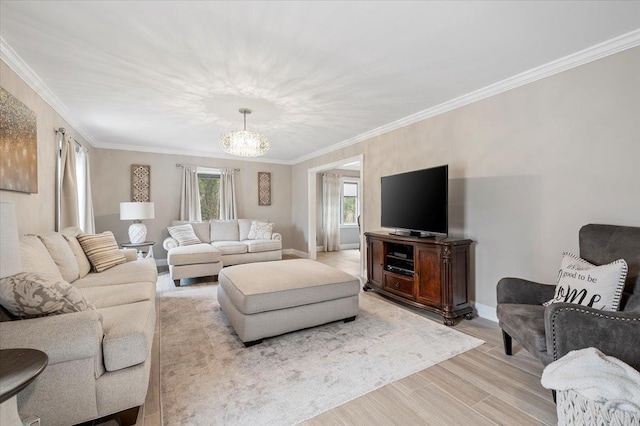 living area with an inviting chandelier, crown molding, baseboards, and light wood-type flooring