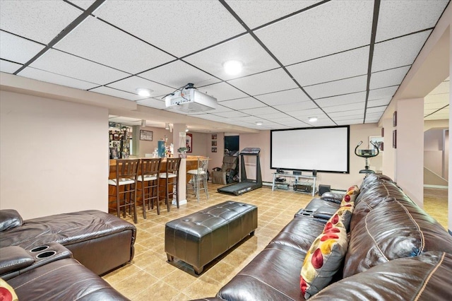 home theater with indoor bar and a paneled ceiling