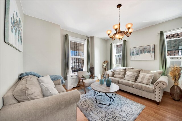 820 S Oak Dr, Bronx, NY 10467 - living area with light wood-type flooring and an inviting chandelier