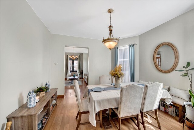 820 S Oak Dr, Bronx, NY 10467 - dining area with a notable chandelier and light wood-style floors