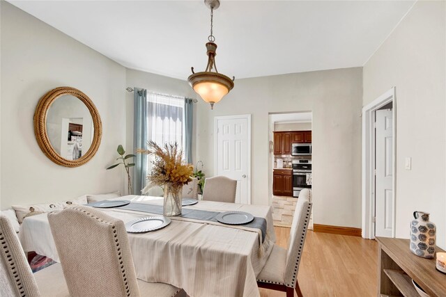 820 S Oak Dr, Bronx, NY 10467 - dining space with light wood-style floors and baseboards