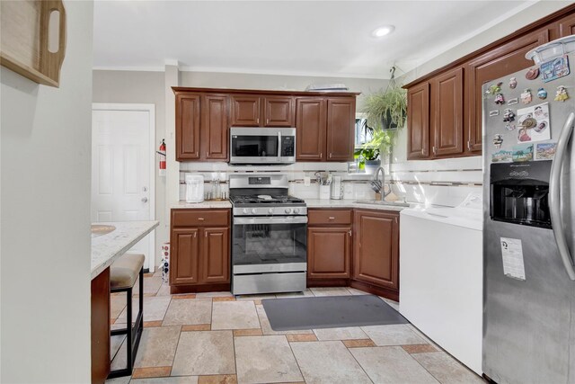 820 S Oak Dr, Bronx, NY 10467 - kitchen featuring a sink, stone tile flooring, appliances with stainless steel finishes, crown molding, and brown cabinets