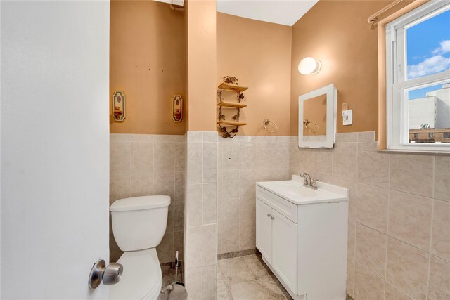 820 S Oak Dr, Bronx, NY 10467 - bathroom with toilet, tile patterned floors, vanity, and tile walls