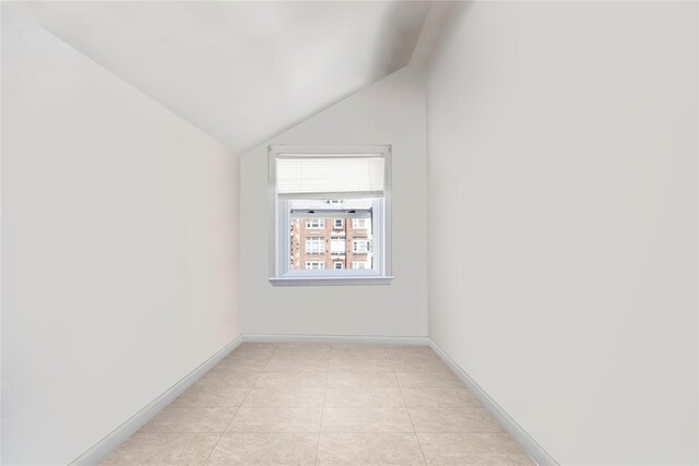 820 S Oak Dr, Bronx, NY 10467 - unfurnished room with light tile patterned flooring, baseboards, and lofted ceiling