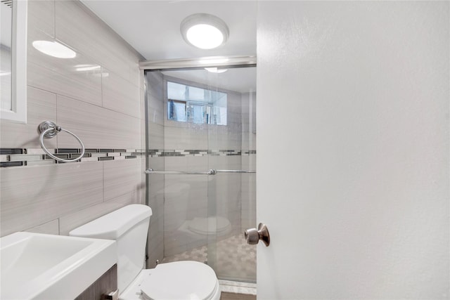 820 S Oak Dr, Bronx, NY 10467 - bathroom with a sink, tile walls, toilet, and a stall shower