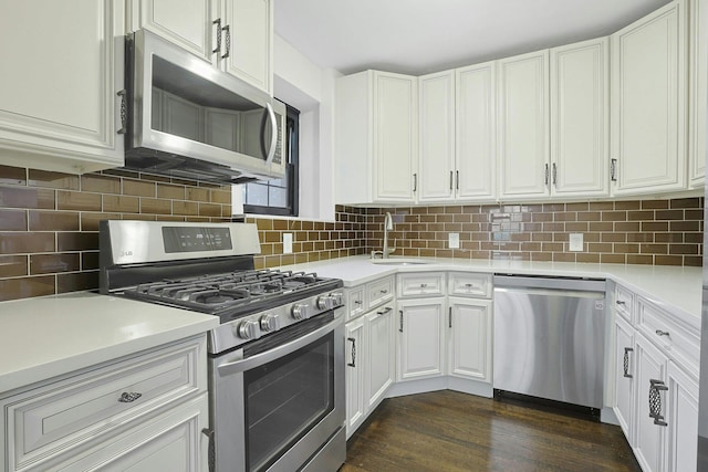 1273 N Ave Unit 1Ab, New Rochelle, NY 10804 - kitchen with appliances with stainless steel finishes, a sink, white cabinetry, dark wood-type flooring, and light countertops