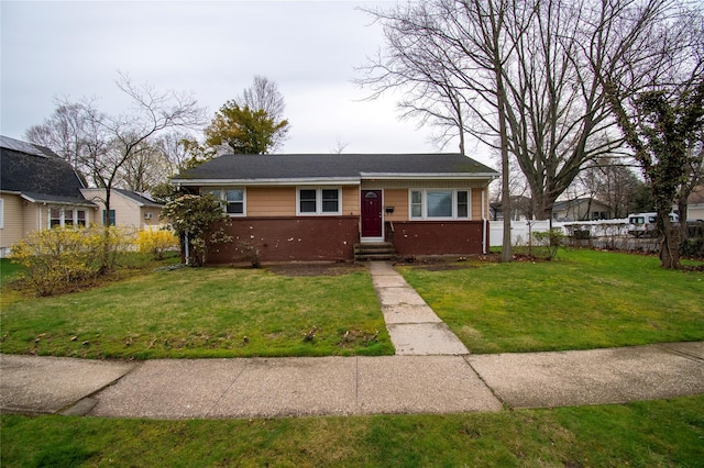 bungalow-style house featuring a front yard, brick siding, fence, and a chimney