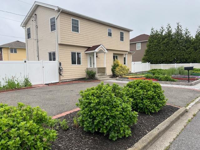 1 E Saltaire Rd, Lindenhurst, NY 11757 - colonial inspired home featuring fence and a gate