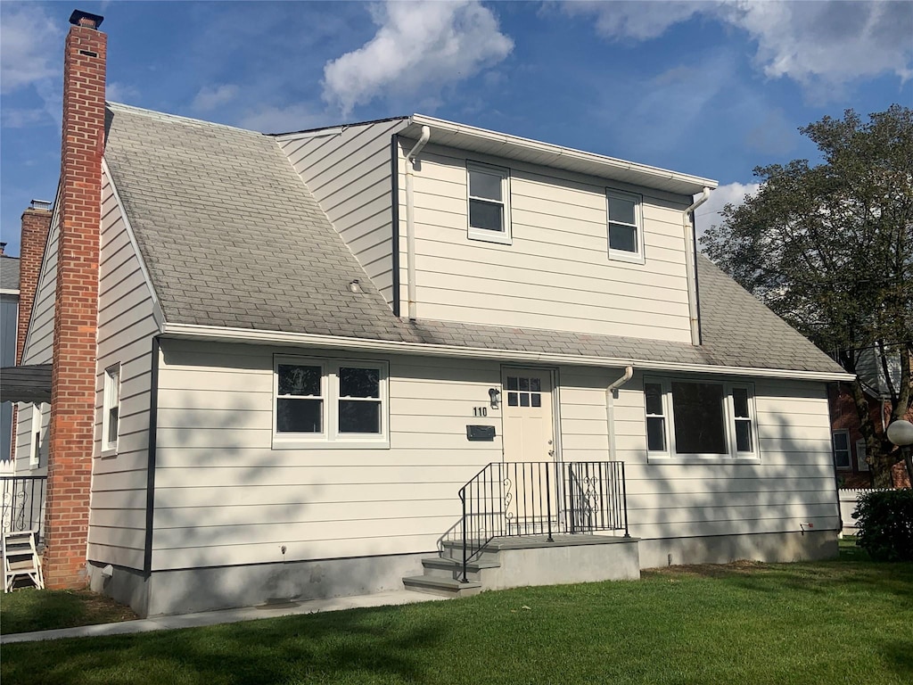 110 Mclean Ave, White Plains, NY 10607 - view of front of property featuring a chimney, a shingled roof, and a front yard