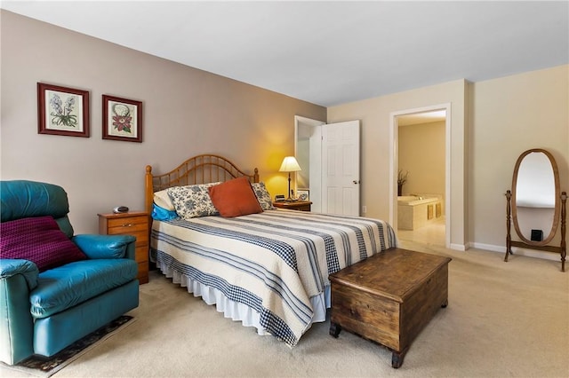 bedroom with connected bathroom, light colored carpet, and baseboards