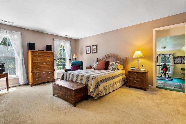 bedroom with light colored carpet and visible vents