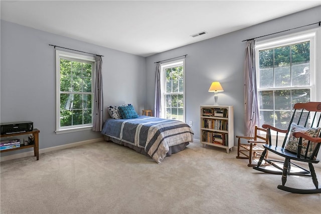 carpeted bedroom featuring baseboards and visible vents