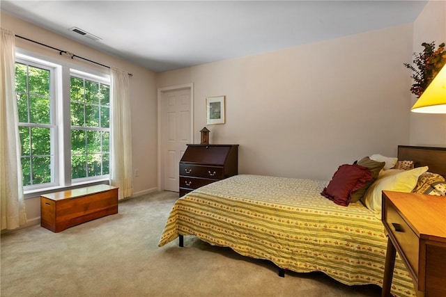 bedroom featuring carpet flooring and visible vents