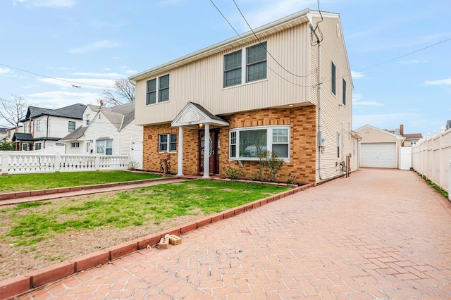 327 Peninsula Blvd, Cedarhurst, NY 11516 - view of front of home featuring an outdoor structure, decorative driveway, a front yard, brick siding, and fence