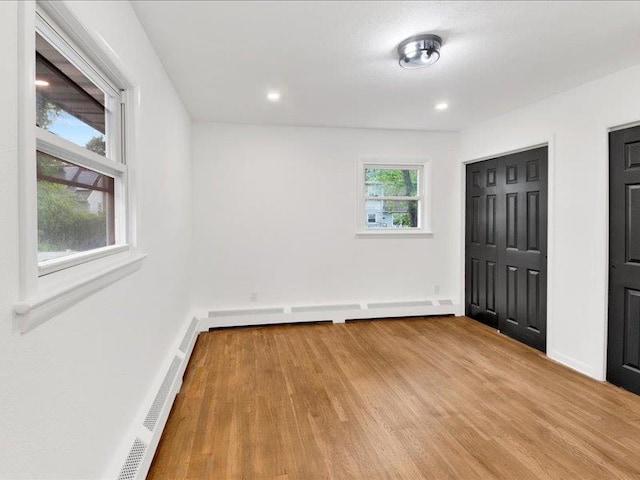 166 Sears Ave, Elmsford, NY 10523 - unfurnished bedroom with wood finished floors, a baseboard radiator, baseboards, and recessed lighting
