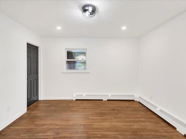 166 Sears Ave, Elmsford, NY 10523 - empty room with wood finished floors, baseboards, recessed lighting, and a baseboard radiator