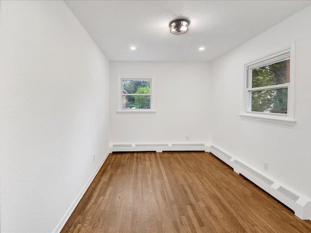 166 Sears Ave, Elmsford, NY 10523 - unfurnished room with a baseboard heating unit, baseboards, and wood finished floors
