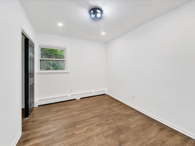 166 Sears Ave, Elmsford, NY 10523 - spare room featuring wood finished floors, baseboard heating, baseboards, and recessed lighting