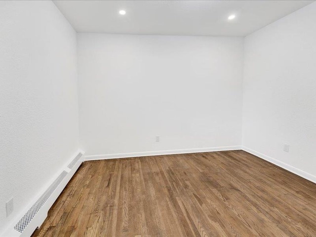166 Sears Ave, Elmsford, NY 10523 - spare room with baseboard heating, wood finished floors, baseboards, and recessed lighting