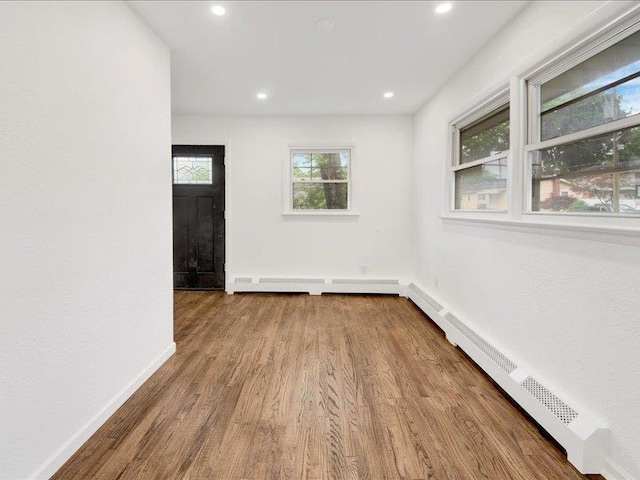 166 Sears Ave, Elmsford, NY 10523 - spare room featuring wood finished floors, a baseboard heating unit, baseboards, and recessed lighting