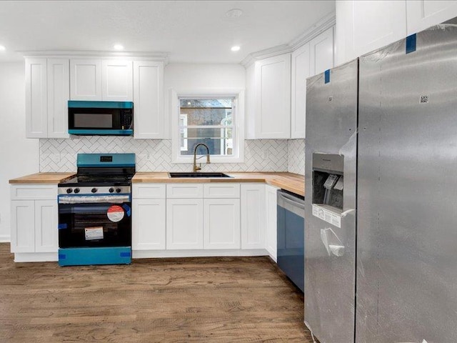 166 Sears Ave, Elmsford, NY 10523 - kitchen featuring stainless steel appliances, wooden counters, a sink, tasteful backsplash, and recessed lighting