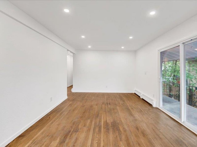 166 Sears Ave, Elmsford, NY 10523 - unfurnished room with baseboard heating, wood finished floors, recessed lighting, and baseboards