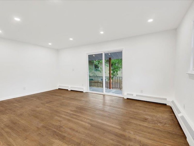 166 Sears Ave, Elmsford, NY 10523 - empty room with wood finished floors, recessed lighting, and baseboard heating