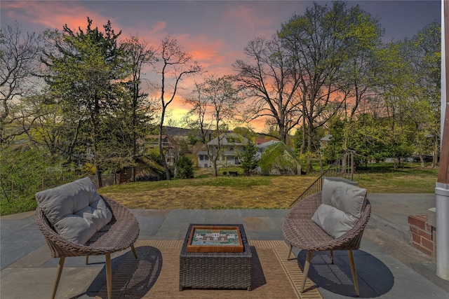 patio terrace at dusk with a yard and a fire pit