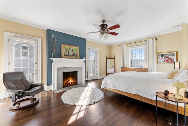 bedroom with ornamental molding, wood finished floors, and access to exterior