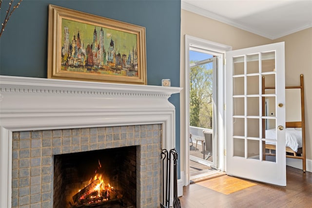 details with ornamental molding, wood finished floors, and a fireplace